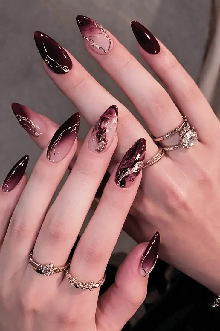 Burgundy marble almond gel nails with gold foil swirls — luxury nail art 78745 ATX at Le Posh